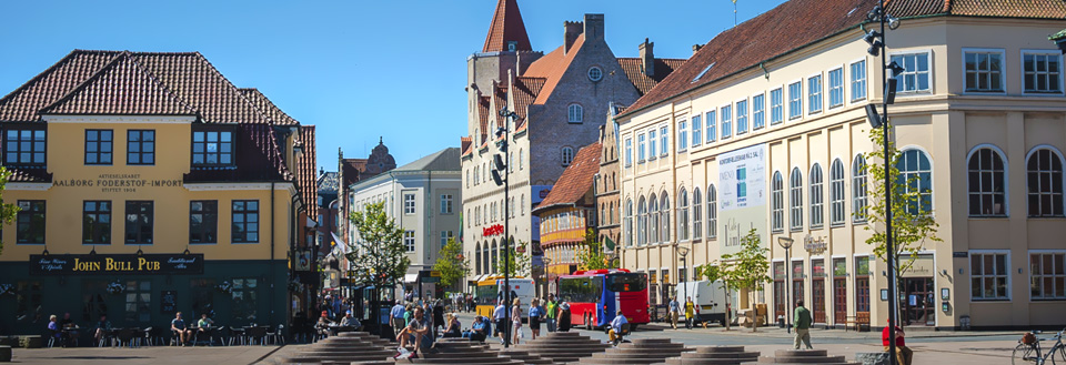 Nytorv og Boulevarden i Aalborg med bygninger, mennesker der går, og en rød bus.