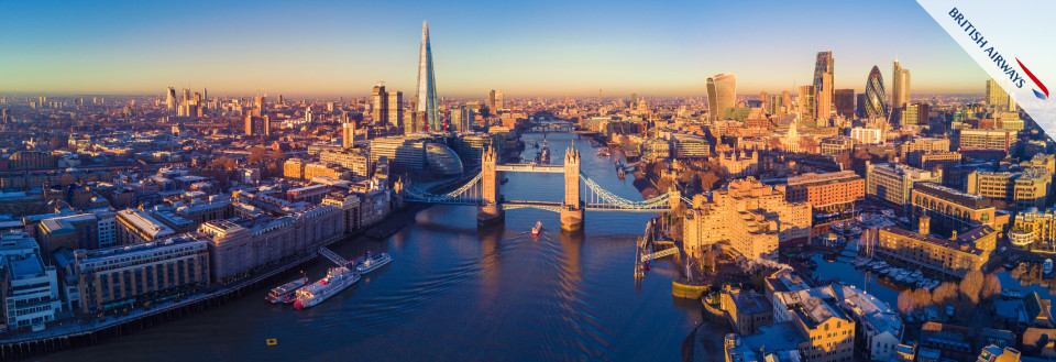 Luftfoto af London ved solnedgang med Tower Bridge og skyline, inklusive The Shard.